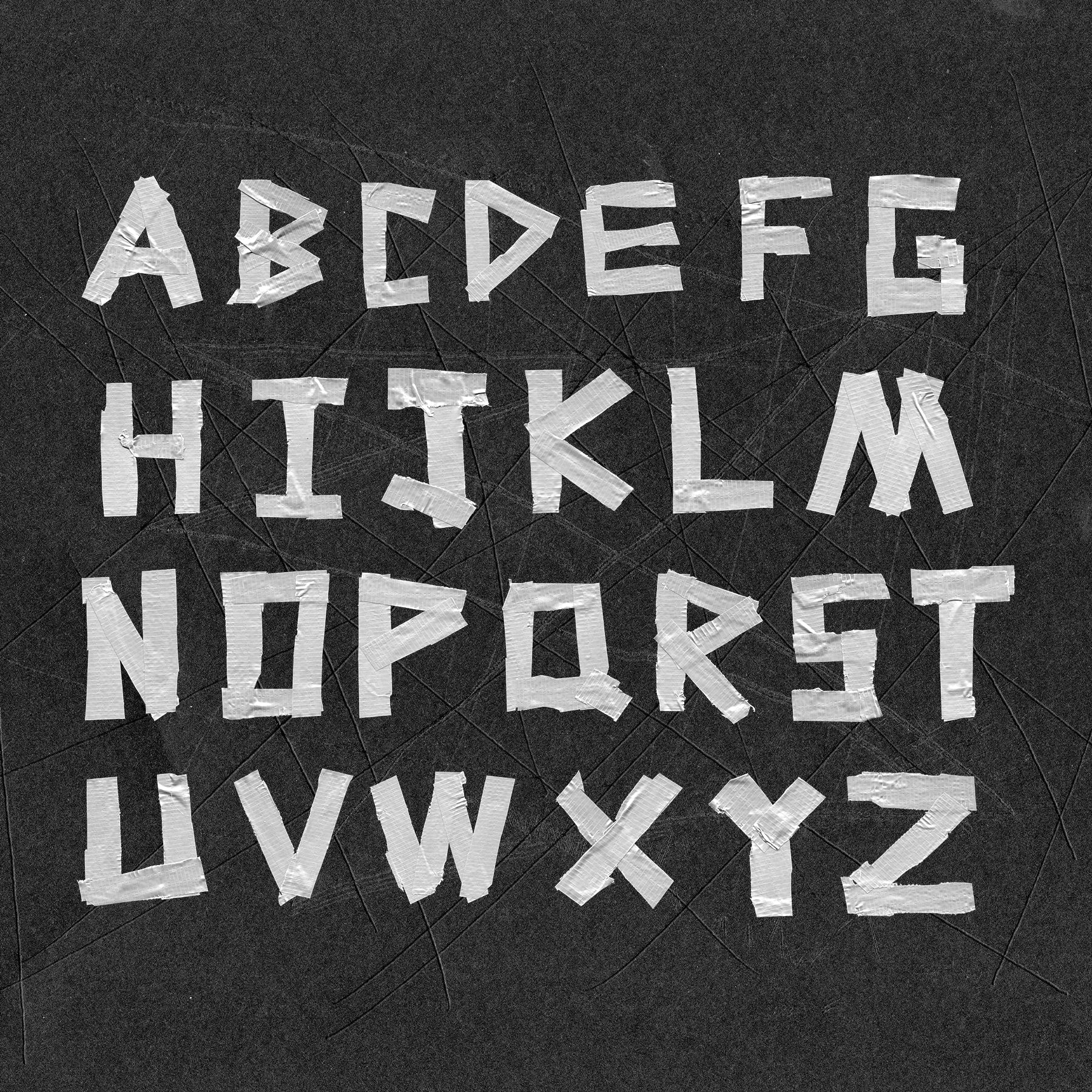 Text made out of duct tape on a textured background that reads "ABCDEFGHIJKLMNOPQRSTUVWXYZ".